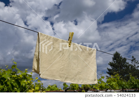 Clothes peg on a blue towel and washing line 54024133
