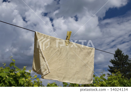 Clothes peg on a blue towel and washing line 54024134