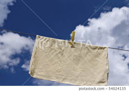 Clothes peg on a blue towel and washing line 54024135