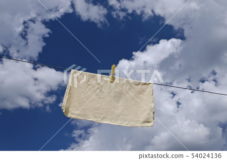 Clothes peg on a blue towel and washing line 54024136
