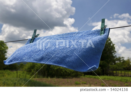 Clothes peg on a blue towel and washing line Clothes peg on a blue towel and washing line 54024138