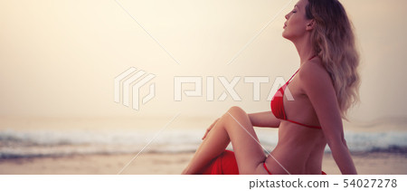 sexy blond woman in red bikini sitting on the 54027278