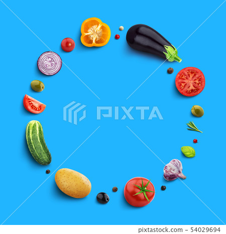 Vegetables on blue background, top view, round frame of vegetable with empty space for text 54029694