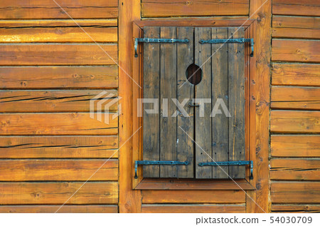 Log Wall with Closed Wooden Window Shutters Log Wall with Closed Wooden Window Shutters 54030709
