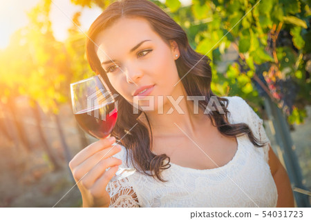 Beautiful Young Adult Woman Enjoying Glass of Wine Beautiful Young Adult Woman Enjoying Glass of Wine 54031723