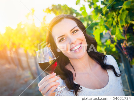 Beautiful Young Adult Woman Enjoying Glass of Wine 54031724
