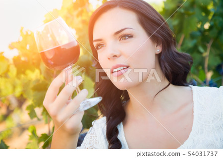 Beautiful Young Adult Woman Enjoying Glass of Wine 54031737