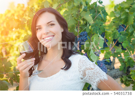 Beautiful Young Adult Woman Enjoying Glass of Wine Beautiful Young Adult Woman Enjoying Glass of Wine 54031738