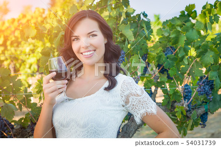 Beautiful Young Adult Woman Enjoying Glass of Wine Beautiful Young Adult Woman Enjoying Glass of Wine 54031739