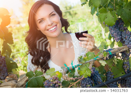 Beautiful Young Adult Woman Enjoying Glass of Wine 54031763