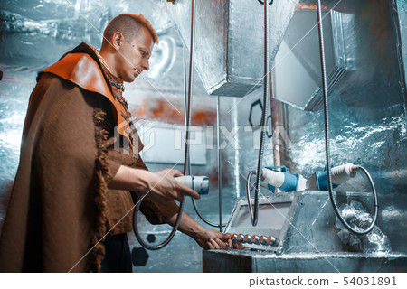 Space scientist holds an unusual instrument 54031891