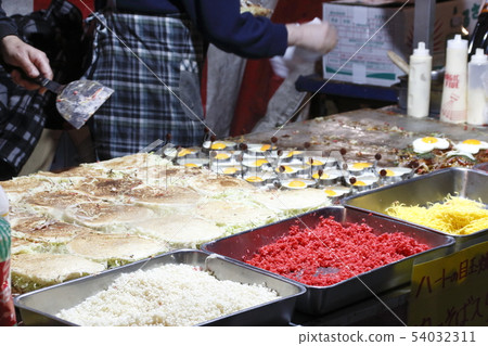 Okonomiyaki with fried egg Okonomiyaki with fried egg 54032311