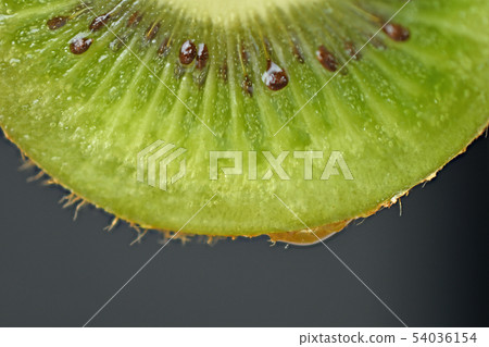 Slices of kiwi fruit on black background Slices of kiwi fruit on black background 54036154