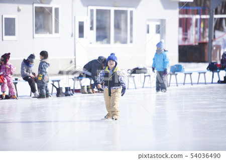 Boy playing on ice rink 54036490