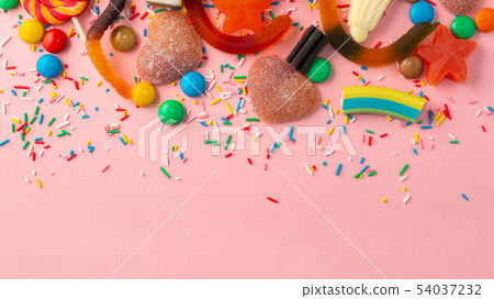 lollipops, candies and sprinkles on pink 54037232