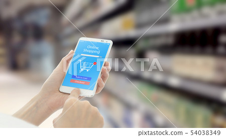 Woman using smart phon while shopping in 54038349