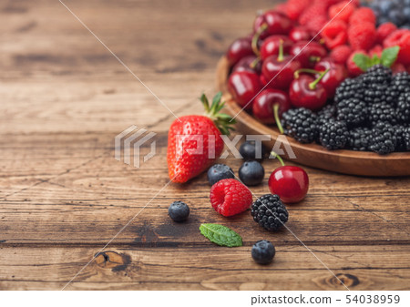 Fresh organic summer berries mix in round wooden Fresh organic summer berries mix in round wooden 54038959
