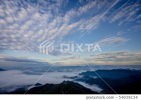 The sea of fog with forests and mountains valley The sea of fog with forests and mountains valley 54039134