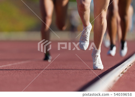 Group of athletes sprinters run speed on track 54039658
