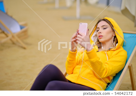 Woman listening music on her headphones Woman listening music on her headphones 54042172