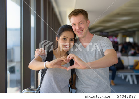 Portrait of young multi-ethnic couple enjoying vacation together Portrait of young multi-ethnic couple enjoying vacation together 54042888