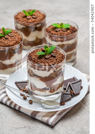 Classic tiramisu dessert in a glass on concrete background 54042907