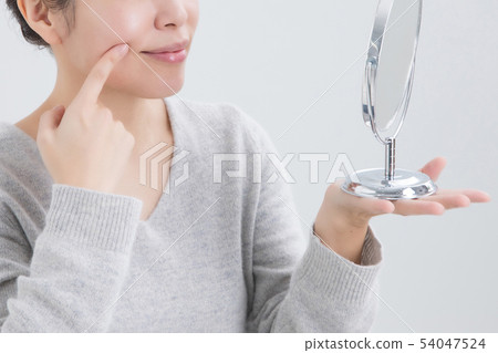 Woman touching her mouth (smile) 54047524