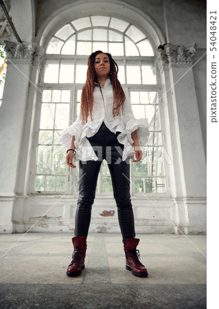 dreadlocks fashionable girl dressed in white shirt 54048421