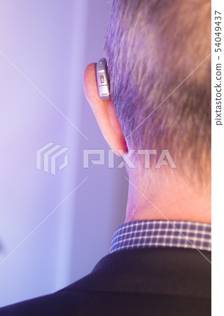 Man with hearing aid Man with hearing aid 54049437