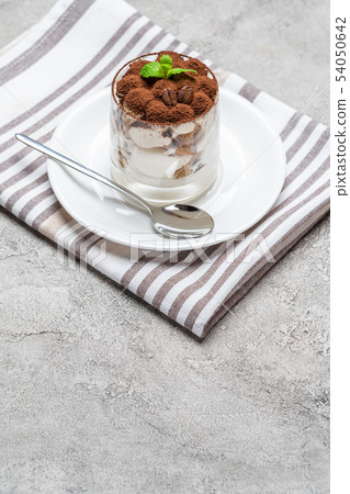 Classic tiramisu dessert in a glass on concrete background 54050642