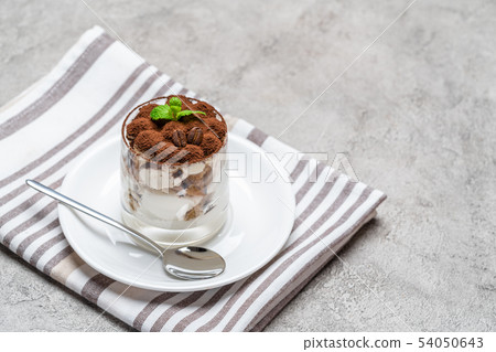 Classic tiramisu dessert in a glass on concrete background 54050643