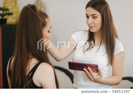 Makeup artist work in her beauty studio. Woman applying by professional make up master. Beautiful Makeup artist work in her beauty studio. Woman applying by professional make up master. Beautiful 54051397
