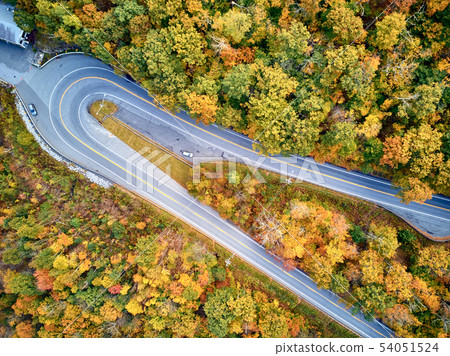 Scenic highway hairpin turn in autumn 54051524