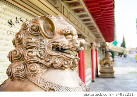 在中國餐館前面安置的一頭金黃獅子的雕象 在中國餐館前面安置的一頭金黃獅子的雕象 54052231