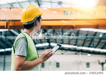 Young Asian male factory worker using a digital tablet 54052495
