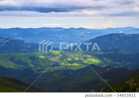 Bright rolling countryside around a farm in the morning light. Picturesque day and gorgeous scene 54053911