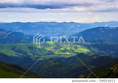 Beautiful swiss alps. Amazing mountain view with high peaks, green hills and clouds low in the Beautiful swiss alps. Amazing mountain view with high peaks, green hills and clouds low in the 54053913