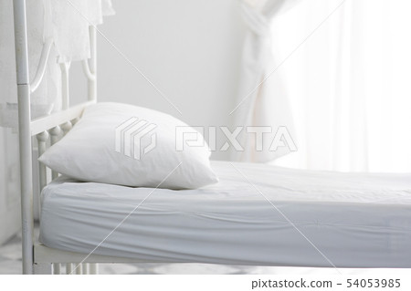 empty white bed and pillow in bedroom 54053985