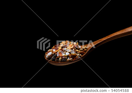 Mixture of spices for culinary mill on wooden spoon over black background. Mixture of spices for culinary mill on wooden spoon over black background. 54054588