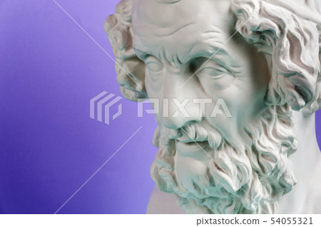 Gypsum copy of ancient statue Homer head on a blue background. Plaster sculpture man face. 54055321