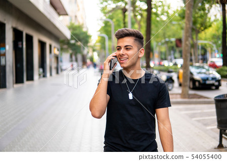 man on the street talking on a cell phone 54055400