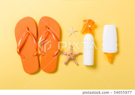 Sunscreen bottle or body spray on yellow 54055977