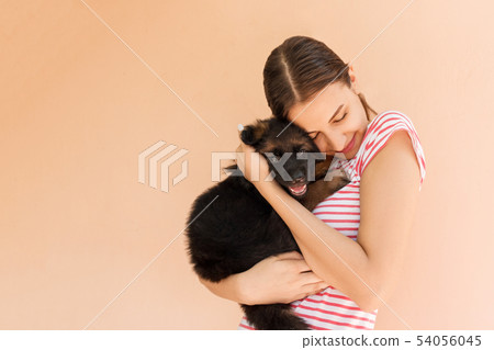 Young beautiful woman with a black puppy. Nice 54056045