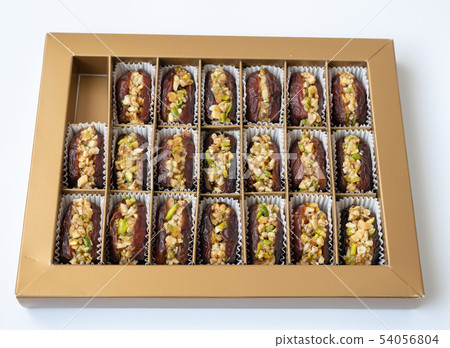 Dates stuffed with pistachios in a box Dates stuffed with pistachios in a box 54056804