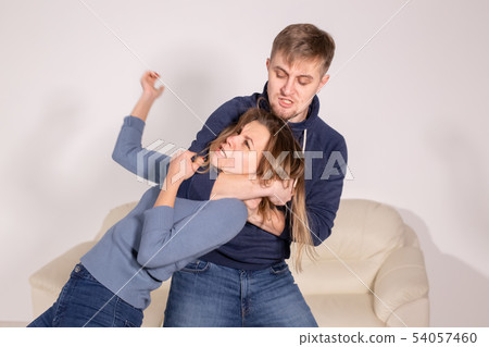 People, abuse and violence concept - aggressive man strangling his wife 54057460
