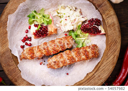Traditional Adana kebab on wooden plate 54057982