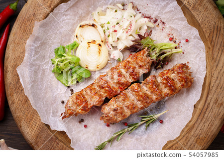 Traditional Adana kebab on wooden plate 54057985