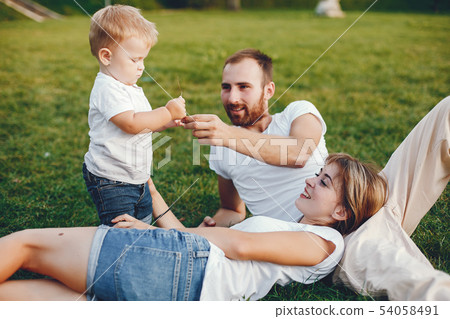 Family with son playing in a summer park 54058491
