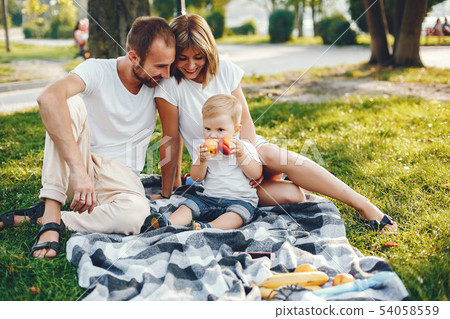 Family with son playing in a summer park Family with son playing in a summer park 54058559