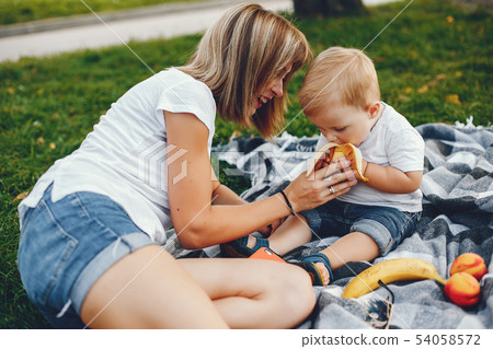 Mother with son playing in a summer park Mother with son playing in a summer park 54058572